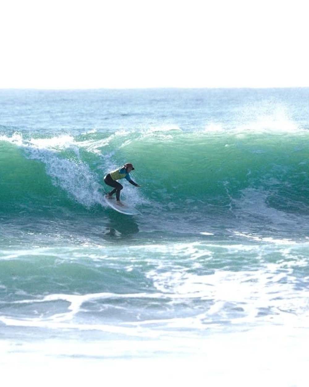 A surfer riding a clean right-hand wave at Jeffreys Bay